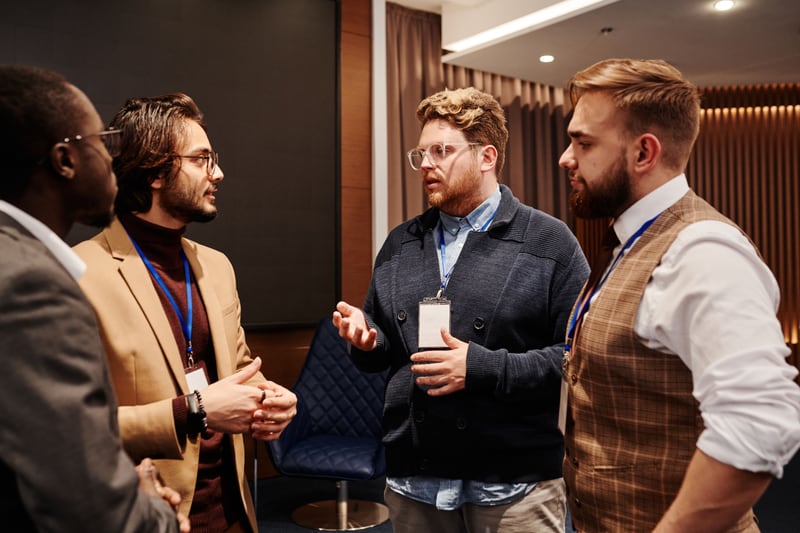 Business event attendees talking together during a networking break.